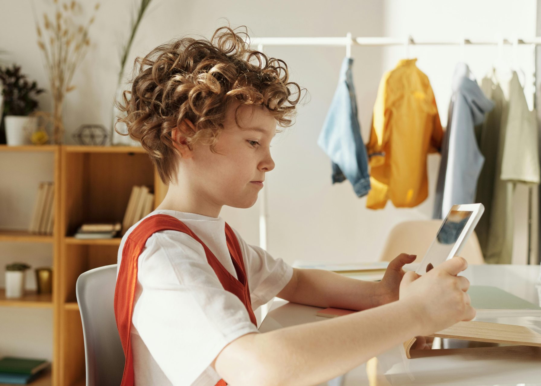 gen alpha (child) holding tablet