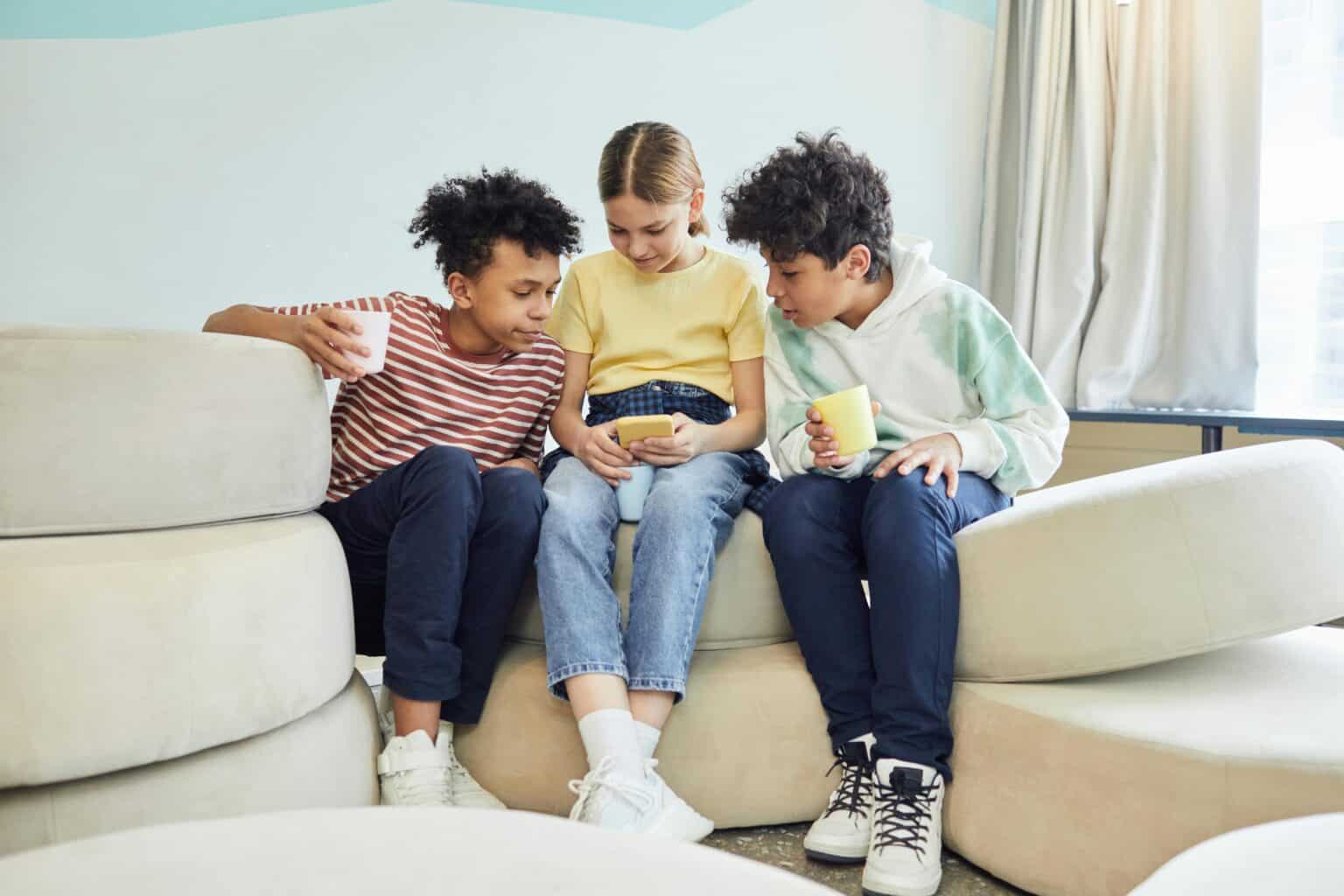 3 gen alphas (Children) looking at phone