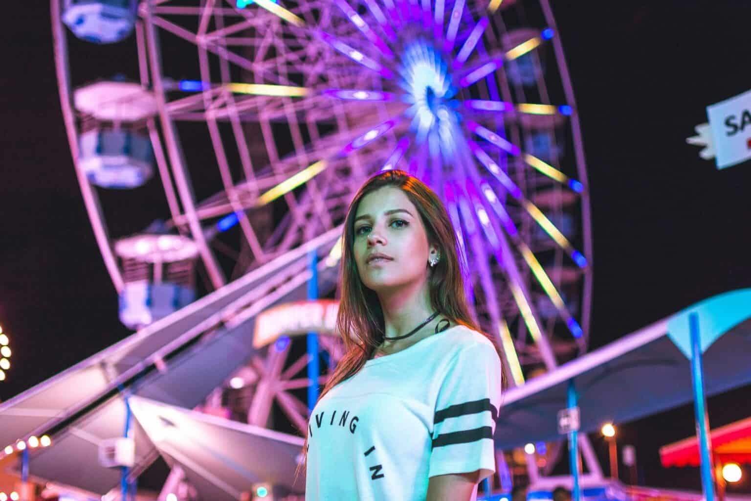 woman standing in front of coachella ferris wheel