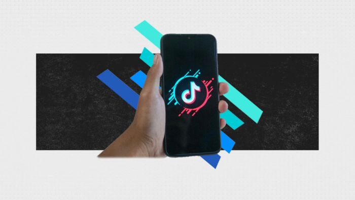 Mobile Phone Being Held In Hand With Tiktok Logo On Screen.