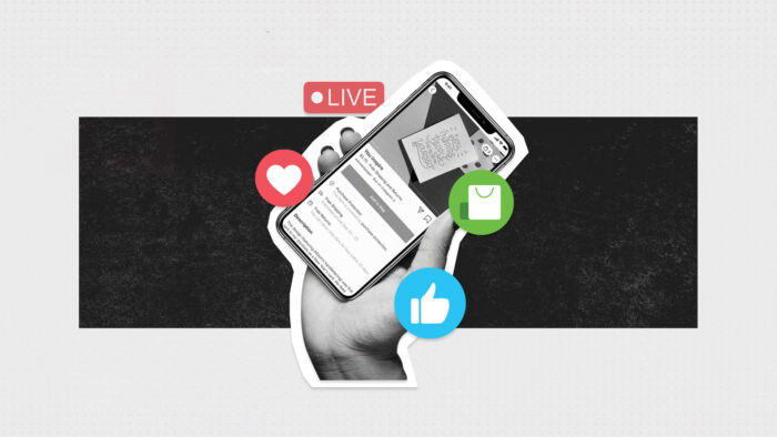 Phone In Hand Displaying Social Commerce Social Feature With Live, Heart, Thumbs Up And Shopping Icon Surrounding. 