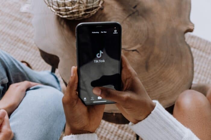 A Phone In A Persons Hands With Tiktok Loading On The Screen. Tech Brands Are Increasingly Using The Platform For Marketing.